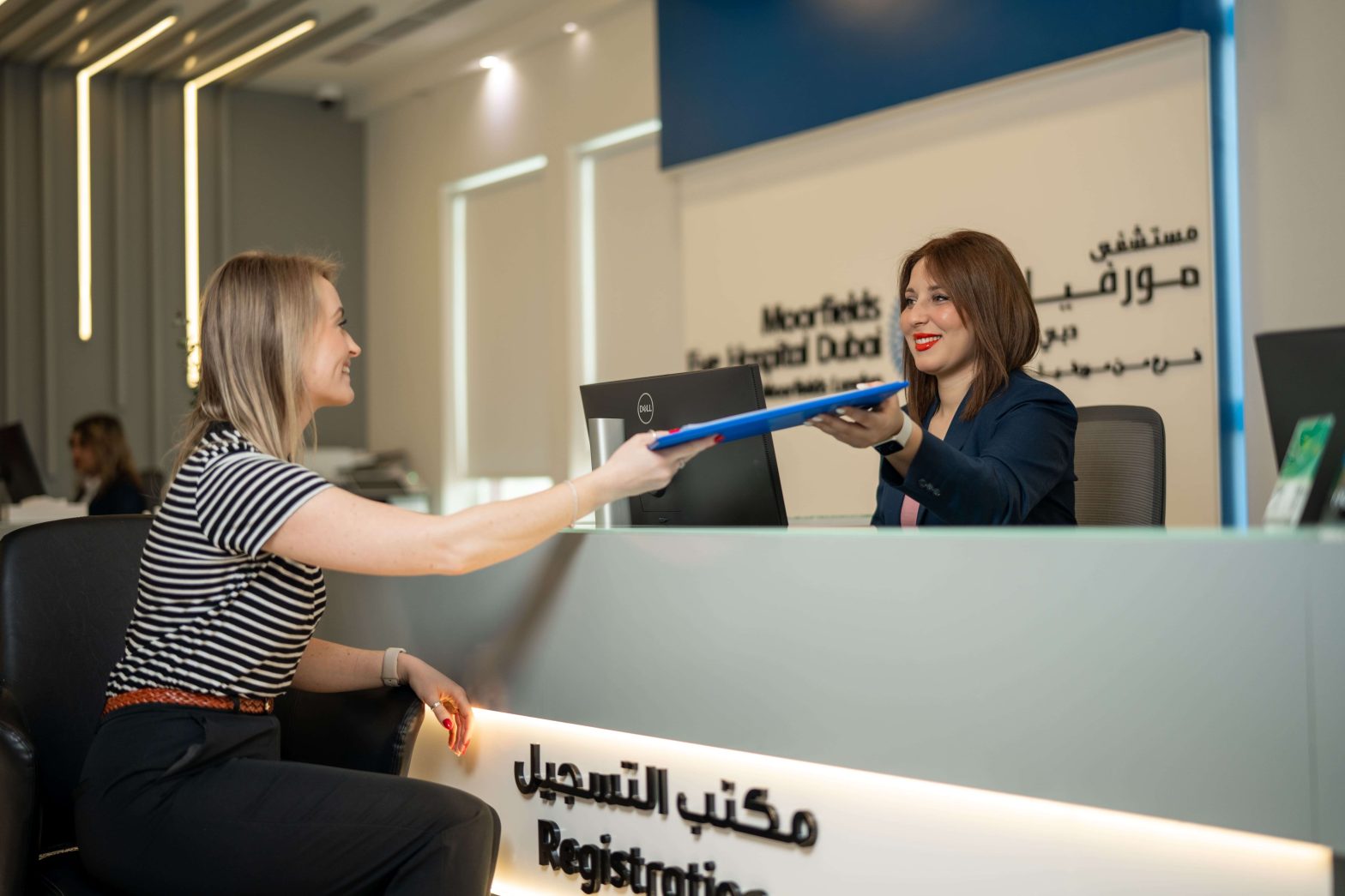 Patient registering at Moorfields Eye Hospital Dubai reception desk